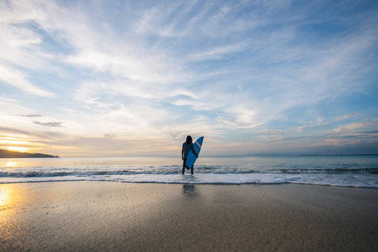 Surfer On Beach In Sunrise