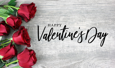 Happy Valentine's Day Calligraphy with Red Roses Over Rustic Wood Background - obrazy, fototapety, plakaty
