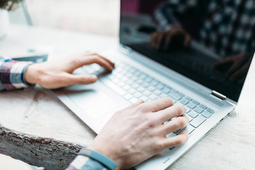 Hands close-up, typing on the laptop keyboard
