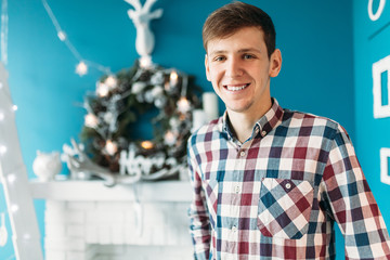 Beautiful portrait of a man, in shirt, Christmas studios, Christmas cheer