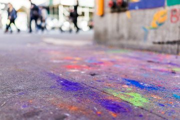 Macro closeup of colorful chalk art on ground with purple, blue and green colors on asphalt street sidewalk in urban New York City, Manhattan