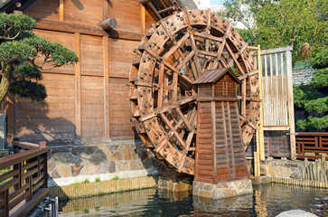 Vintage wooden waterwheel at water mill used to generate power - 187401559