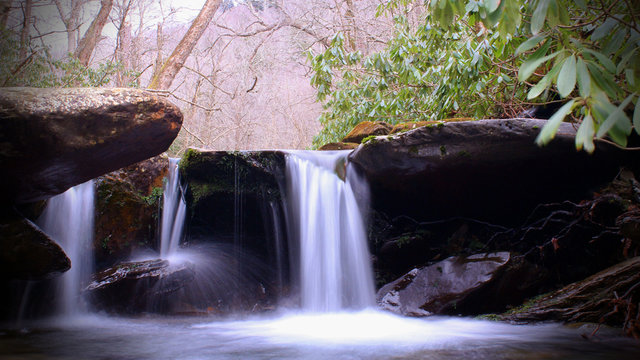 Wide Screen Photo of Waterfall in the Woods Slow Shutter Speed Motion Blurred