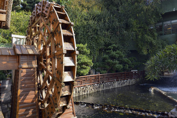 Vintage wooden waterwheel at water mill used to generate power