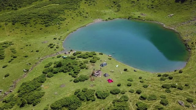 Flight over a mountain lake. Incredible landscape of green mountains in late summer.  Carpathian mountains, Ukraine. Landscape video. Nature video. 4K, 3840*2160, high bit rate, UHD