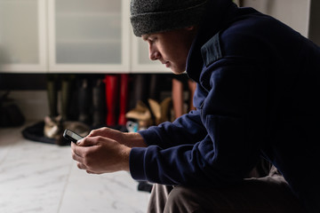 young man looking at his cellphone