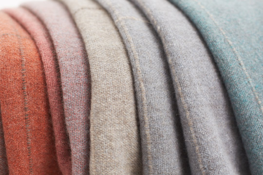 Collection of wool and colorful blankets grouped together