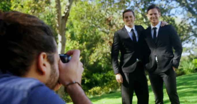 Photographer taking photo of groomsmen  