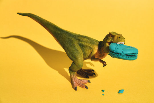 Plastic T-Rex with macaroon in mouth