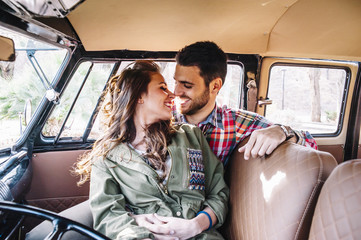 attractive man and woman inside their car