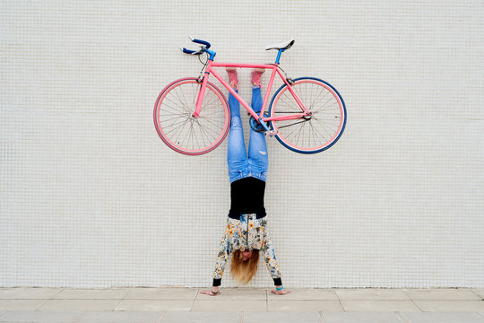 Woman in handstand with fixie.