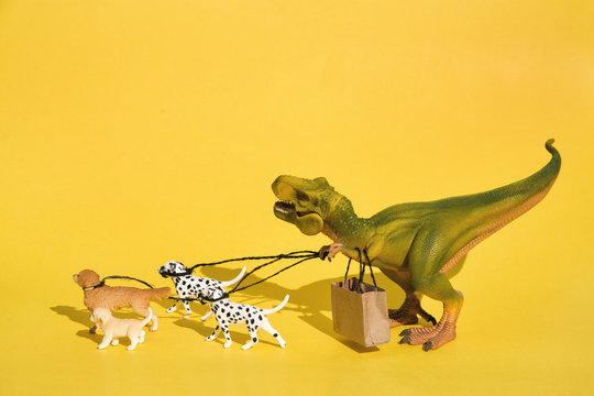 Plastic T-Rex with dogs on walk
