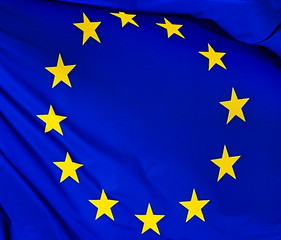 The flag of the European Union , against the background of the sunny sky.