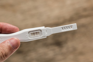 Hand holding pregnancy test