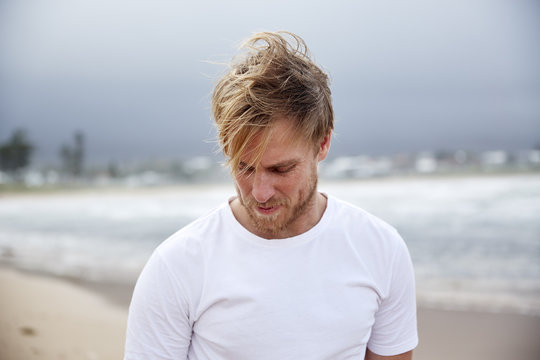 A blonde man on the beach