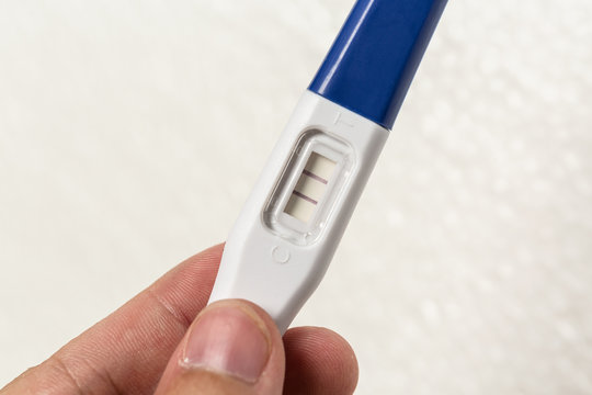 Hand Holding Pregnancy Test