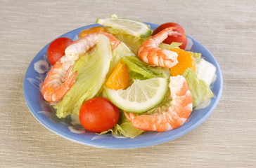 Salad with shrimp and tomatoes on a  plate   