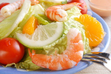 Salad with shrimp and tomatoes on a  plate   