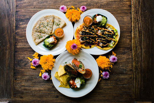 Overhead view of Mexican food decorated with flowers on table
