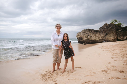 Fun loving grandma with kids on tropical beach