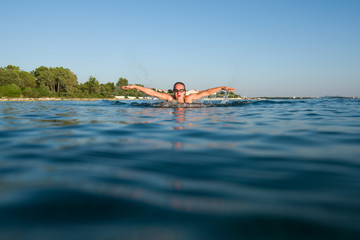 Woman wearing goggles swimming in the sea
