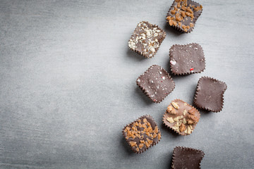 Several kinds of chocolate treats on a stone background.