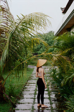 Young woman in tropical alley