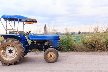 E-taen vehicle or farm tractor in countryside with green organic vegetable farm scenery, Agricultural vehicles