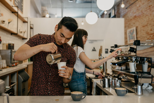 Barista Making Latte in Coffee Shop