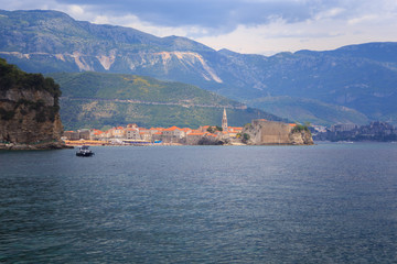Fototapeta na wymiar view from the sea to the old town of Budva on background of green mountains