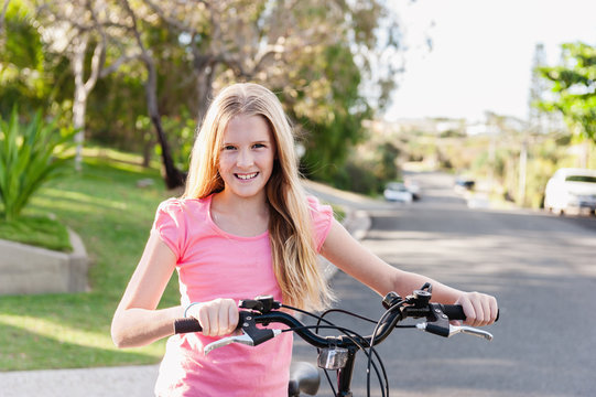 tween girl riding her bike on the road
