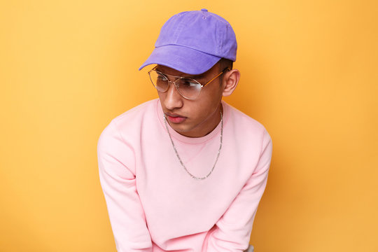 Young man wearing purple baseball cap