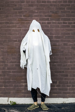 Man in Halloween Ghost Costume Made of Torn Bedsheets