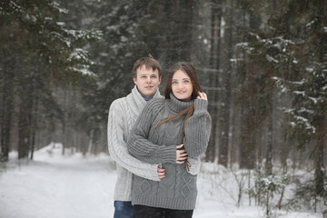 Fototapeta na wymiar pair of lovers on a date winter afternoon in a snow blizzard