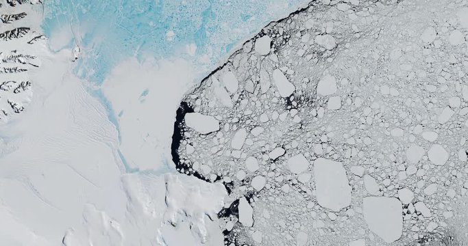 Very high-altitude overflight aerial of Antarctic glaciers, ice sheets, nunataks and sea ice. Clip loops and is reversible. Elements of this image furnished by USGS/NASA Landsat