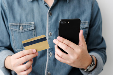 Man hands using smart phone and holding credit card, shopping online concept, mobile banking, business and technology