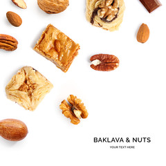 Creative layout made of baklava and nuts. Flat lay. Food concept. Baklava, almonds, pecan and walnut on the white background