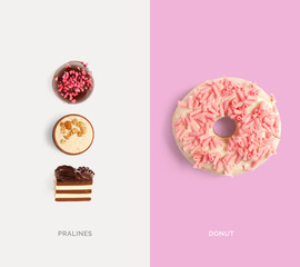 Creative layout made of pink donut and chocolate pralines. Flat lay. Food concept. Macro  concept.