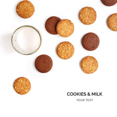Creative layout made of cookies and glass of milk. Flat lay. Food concept. Cookies and glass of milk on the white background
