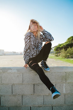 Beautiful blonde woman in striped hoodie