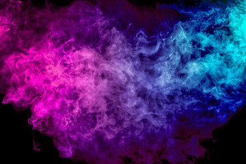 Thick colorful smoke of purple, blue, white on a black isolated background. Background from the...