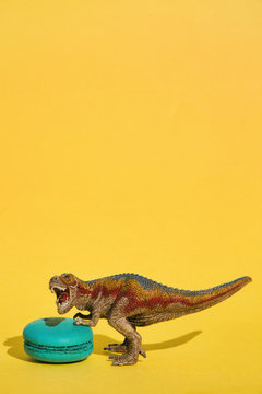 Small T-Rex defending sweet macaroon