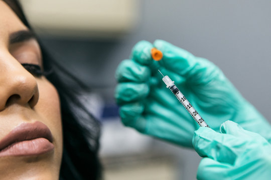Close-up Woman Receives Cosmetic Injection from Nurse