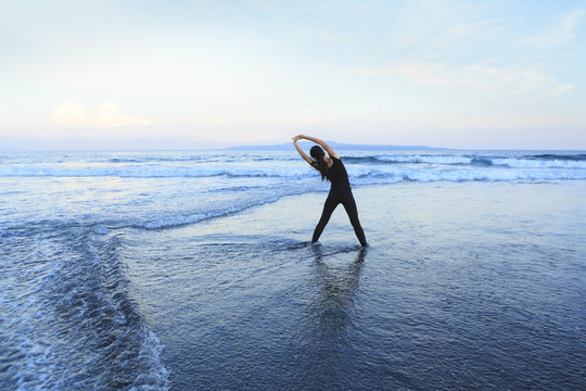Asian woman running  at a beach