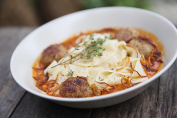 Pasta meatballs tomato sauce on wood background