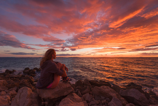 Woman admiring the seascape during sunrise