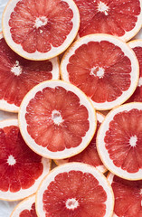 Food background. Cut fresh ripe grapefruit, top view, flat lay. Free space for text