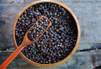 Close up black pepper seed in wooden spoon
