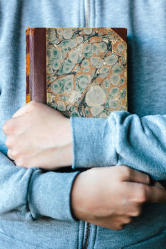 Young Boy Holding A Vintage Book