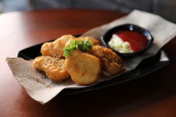 Nuggets on wood background vintage style , appetizer